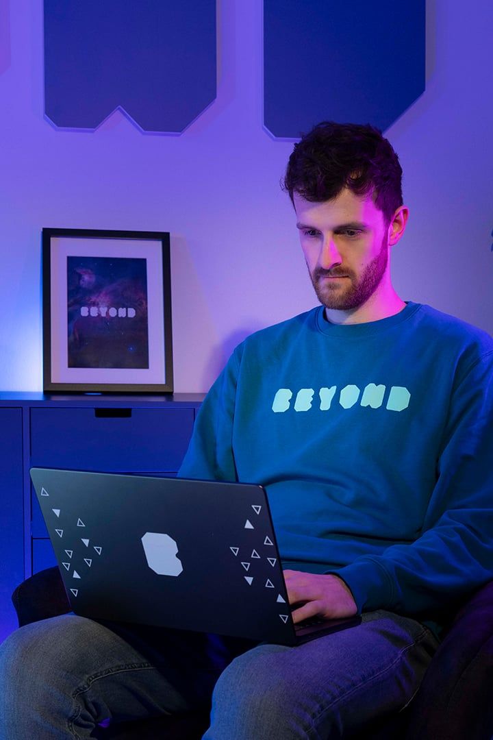 BEYONDIT developer working focused on a laptop