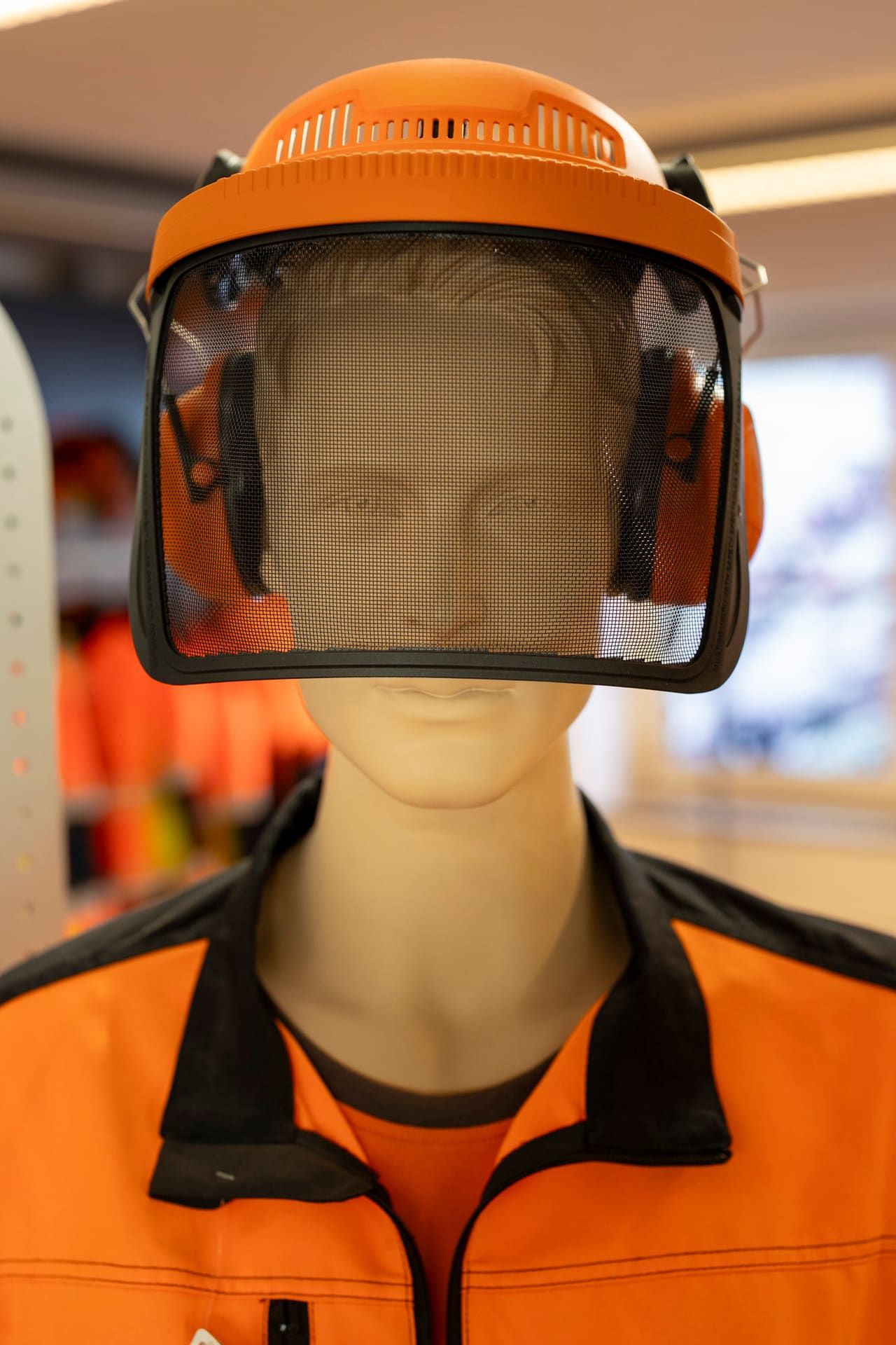 Forestry helmet with visor and ear defenders in the showroom