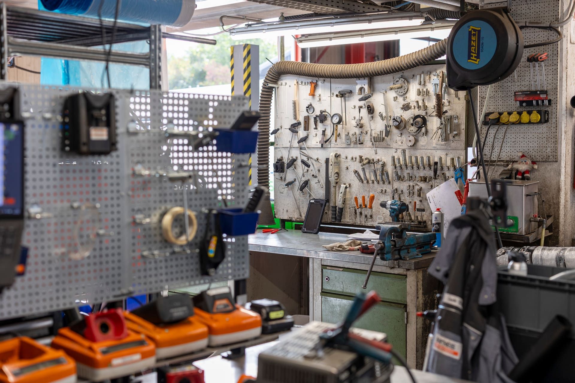 Workbench with pegboard, batteries and tools